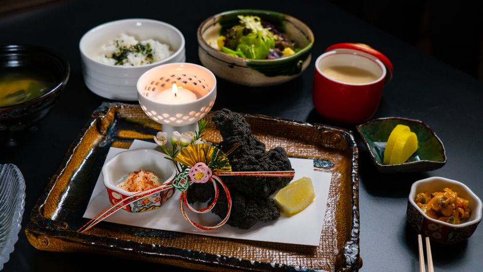 Traditional ryokan kaiseki dinner tray with many small Japanese dishes