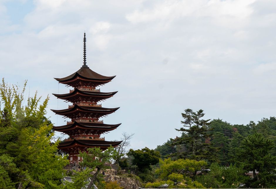 Five-storey pagoda of Miyajima at dusk with warm lantern light