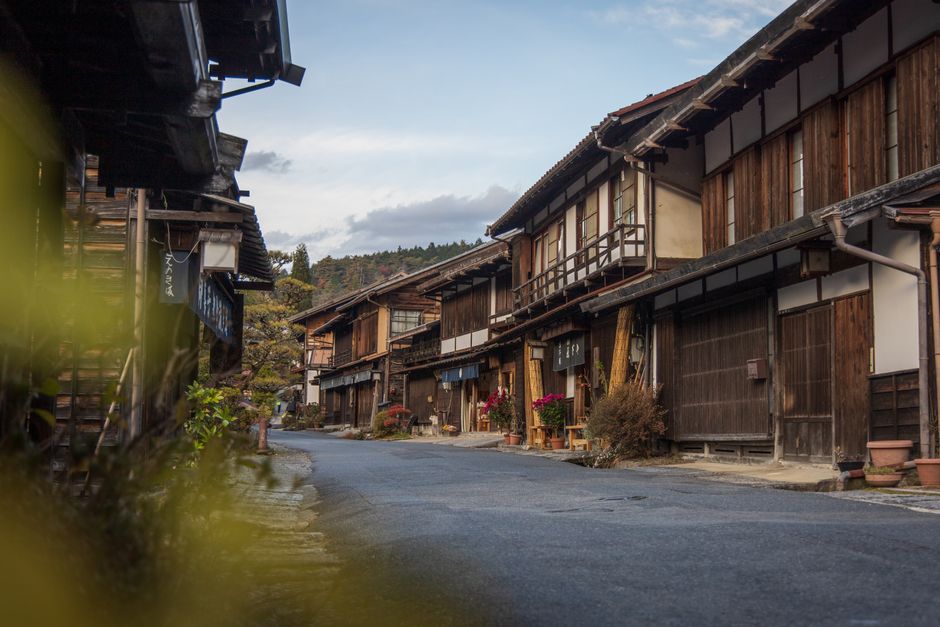 Tsumago post town street at dusk with traditional buildings and paper lanterns