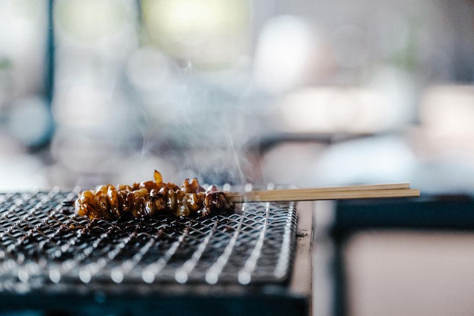 Grilled goheimochi rice cakes glazed with miso on wooden skewers